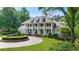 A stunning two-story house with a circular driveway, a fountain, and a well-manicured front yard at 5045 Harrington Rd, Johns Creek, GA 30022