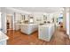 Spacious kitchen with double islands and hardwood floors leading into living area at 5045 Harrington Rd, Johns Creek, GA 30022