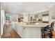 Bright kitchen features custom cabinets, an island with bar seating, stainless steel appliances and hardwood floors at 5045 Harrington Rd, Johns Creek, GA 30022