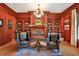 Sophisticated library with rich wood paneling, built-in bookshelves, a fireplace, and comfortable seating at 5045 Harrington Rd, Johns Creek, GA 30022