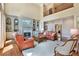 Spacious living room with a fireplace, hardwood floors, built-in shelving, and ample natural light at 5045 Harrington Rd, Johns Creek, GA 30022