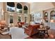 Bright living room features high ceilings, large windows, hardwood floors, and built-in shelving at 5045 Harrington Rd, Johns Creek, GA 30022