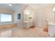 Elegant main bathroom with soaking tub, separate vanities, and marble floors at 5045 Harrington Rd, Johns Creek, GA 30022