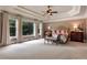Bright main bedroom with large windows, tray ceiling, and neutral tones for a peaceful retreat at 5045 Harrington Rd, Johns Creek, GA 30022