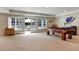 Finished basement featuring a pool table, sliding glass doors to the pool, and neutral carpeting at 5045 Harrington Rd, Johns Creek, GA 30022