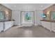 Luxurious bathroom featuring a soaking tub, dual vanities, decorative wallpaper, and large windows with an outdoor view at 5045 Harrington Rd, Johns Creek, GA 30022