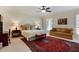 Well-lit bedroom featuring a seating area, rug, and window providing natural light at 5045 Harrington Rd, Johns Creek, GA 30022