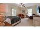 Comfortable bedroom featuring a ceiling fan, plush seating, and a window for natural light at 5045 Harrington Rd, Johns Creek, GA 30022