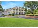 Stately white home with grand columns, a circular driveway, and meticulously landscaped grounds at 5045 Harrington Rd, Johns Creek, GA 30022