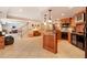 Open-concept kitchen with a center island, granite countertops, wine cooler, and tile flooring at 5045 Harrington Rd, Johns Creek, GA 30022