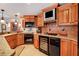 Close-up of the kitchen with custom wood cabinets, granite countertops, and a built-in wine cooler at 5045 Harrington Rd, Johns Creek, GA 30022