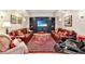 Comfortable living room with plush leather sofas, a patterned rug, and a built-in entertainment center at 5045 Harrington Rd, Johns Creek, GA 30022