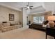 Spacious main bedroom suite featuring a seating area, tray ceiling, and large windows for natural light at 5045 Harrington Rd, Johns Creek, GA 30022
