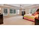 Bright bedroom with a tray ceiling, large windows, plush carpeting, and natural light at 5045 Harrington Rd, Johns Creek, GA 30022