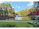 Scenic pond with fountain and lush trees offers a peaceful view for residents at 5045 Harrington Rd, Johns Creek, GA 30022