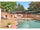 Stunning pool area with hot tub, lounge chairs, built-in grill, and steps up to a seating area at 5045 Harrington Rd, Johns Creek, GA 30022