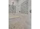 Walk-in shower featuring decorative tiling, a built-in bench, and modern shower fixtures at 5045 Harrington Rd, Johns Creek, GA 30022