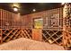 View of wine cellar with ample storage, custom racks, brick floors, and a cozy, inviting atmosphere at 5045 Harrington Rd, Johns Creek, GA 30022