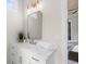 Bright bathroom featuring marble countertops, gold accents, and a decorative vanity mirror at 515 Godfrey Dr, Cumming, GA 30040