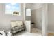 This modern shower features gray tiling and a bench, complemented by bright natural light from a nearby window at 515 Godfrey Dr, Cumming, GA 30040