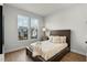 This naturally lit bedroom has hardwood floors and a cozy bed with fluffy pillows and blankets at 515 Godfrey Dr, Cumming, GA 30040