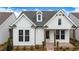 Charming exterior showcasing white siding, dormer window, and brick entryway at 515 Godfrey Dr, Cumming, GA 30040