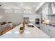 Open kitchen design showcasing white cabinets, stainless steel appliances, quartz countertops, and seamless access to the living area at 515 Godfrey Dr, Cumming, GA 30040