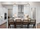Bright kitchen boasts white cabinetry, stainless steel appliances, and an island with barstool seating and quartz countertops at 515 Godfrey Dr, Cumming, GA 30040