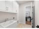 Functional laundry room with bright white cabinets, modern appliances, and ample storage space at 515 Godfrey Dr, Cumming, GA 30040