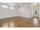 Spacious living room with hardwood floors, a ceiling fan, and ample natural light from clerestory windows at 515 Godfrey Dr, Cumming, GA 30040