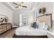 This tranquil main bedroom includes a tray ceiling, fan, a sitting area, and generous natural light at 515 Godfrey Dr, Cumming, GA 30040