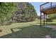 Spacious backyard featuring ample green space, mature trees, and a deck at 915 Terance Ave, Jonesboro, GA 30238