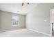 Bedroom features a window, neutral paint, plush carpet, and a ceiling fan with lighting at 915 Terance Ave, Jonesboro, GA 30238