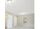 Cozy bedroom showcasing neutral paint, carpet, window, and standard double-door closet at 915 Terance Ave, Jonesboro, GA 30238