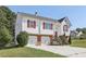 Charming two-story home with red shutters, a two-car garage, and a well-maintained lawn at 915 Terance Ave, Jonesboro, GA 30238