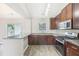 Modern kitchen showcasing granite countertops, stainless steel appliances, dark wood cabinets, and bar seating at 915 Terance Ave, Jonesboro, GA 30238