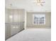 Bright loft featuring carpet, a ceiling fan, large window, and neutral paint, perfect for a home office or play area at 915 Terance Ave, Jonesboro, GA 30238
