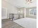 Bright and airy loft area with vaulted ceilings, a ceiling fan, carpet and new laminate floors, and a large window at 915 Terance Ave, Jonesboro, GA 30238
