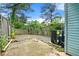 View of the backyard featuring a weathered patio, AC unit and wood privacy fence at 2261 Wellington Cir, Lithonia, GA 30058