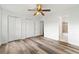 Bedroom featuring wood-look flooring, ceiling fan, two windows, and two closets at 2261 Wellington Cir, Lithonia, GA 30058