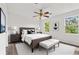 Bedroom features wood-look flooring, ceiling fan, two windows, and neutral decor at 2261 Wellington Cir, Lithonia, GA 30058