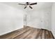Bedroom featuring wood-look flooring, ceiling fan, two windows, and two closets at 2261 Wellington Cir, Lithonia, GA 30058