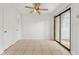 Bright dining area with a sliding glass door to outside, fan, and tile flooring at 2261 Wellington Cir, Lithonia, GA 30058