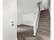 Bright foyer with staircase, hardwood flooring, white door, and natural light streaming in at 2261 Wellington Cir, Lithonia, GA 30058
