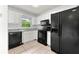 Well-lit kitchen features stainless steel appliances, white cabinets, and a window bringing in natural light at 2261 Wellington Cir, Lithonia, GA 30058