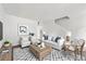 Open living room with a modern rug, stylish furniture, and plenty of natural light from the windows at 2261 Wellington Cir, Lithonia, GA 30058