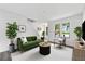 Cozy living room with hardwood floors, white walls, large windows, and stylish furniture at 2261 Wellington Cir, Lithonia, GA 30058