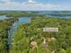 Scenic aerial view showcasing the home's location near a lake and lush greenery, with the address displayed at 3380 Canon Bay Dr, Cumming, GA 30041