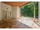 Covered back patio with stone flooring leading to a wooded backyard at 3380 Canon Bay Dr, Cumming, GA 30041