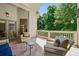 Charming back porch features comfortable seating, an outdoor rug, and serene views of nature at 3380 Canon Bay Dr, Cumming, GA 30041